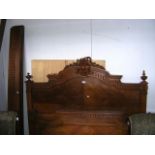 An early 20th century French walnut bed with side