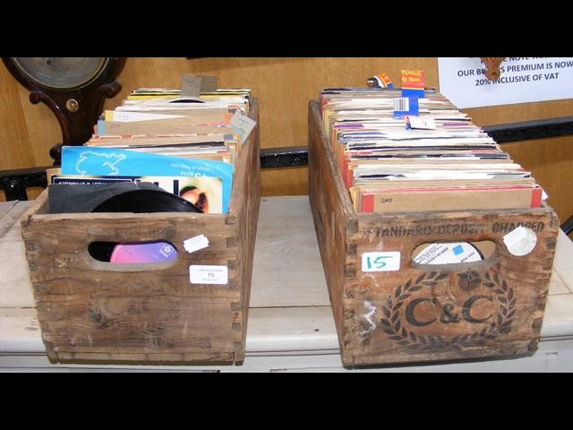 Two vintage bottle crates containing various 45 rp