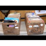 Two vintage bottle crates containing various 45 rp