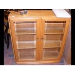 An Ercol 'Golden Dawn' side cabinet, enclosed by a