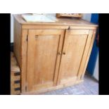 A Victorian pine cupboard enclosed by a pair of pa