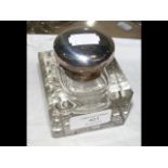 A silver top cut glass inkwell