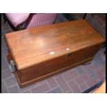 An antique chest with handles to the side