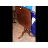 A 19th century mahogany tilt-top table on tripod s