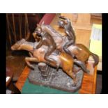 A 32cm high bronze figural group of horse racing