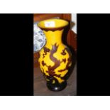 A 28cm high oriental glass vase with dragon design