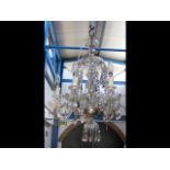 A decorative five branch crystal drop chandelier