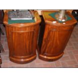 A pair of bow fronted mahogany bedside cabinets -