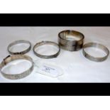 Five silver bangles