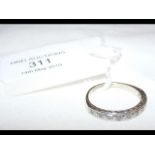 An 18ct white gold diamond half eternity ring