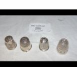 Three hallmarked silver thimbles, together with on