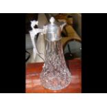 A silver mounted cut glass claret jug - 28cm high
