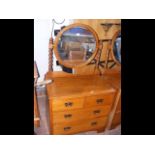 An oak chest of drawers with mirror over