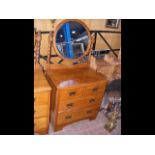 An oak chest of drawers with mirror over