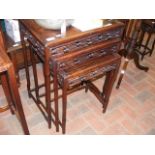 A nest of three oriental hardwood tables