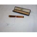 A gold mounted cigarette holder by Rothmans of Pal