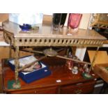 A marble top coffee table with gilt metal under ti