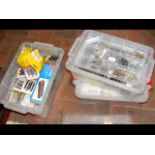 Three plastic containers of train kits and accesso