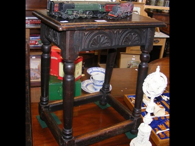 A carved oak joint stool