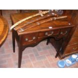 An antique mahogany lowboy with three drawers to t