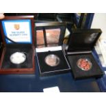 A £5 Silver 'Poppy' Commemorative Coin and two oth