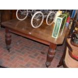 A large Victorian mahogany extending dining table