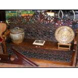 An antique heavily carved settle with hinged lift-