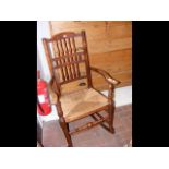 An antique rush seated rocking chair