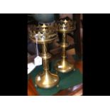 A pair of antique ecclesiastical brass candlestick