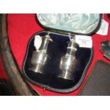 A pair of decorative cased silver salt and peppers