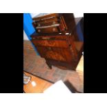 An antique inlaid chest with fitted top drawer