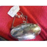 A lady's silver oval purse with chain