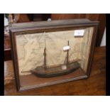 A small wooden model boat in glazed display case -
