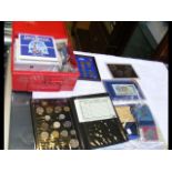 A box of collectable coinage in presentation packs