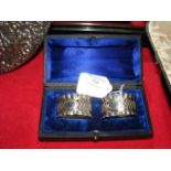 A pair of silver napkin rings in presentation case