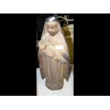 A carved antique religious figure - 54cm high