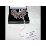 A solid silver butterfly brooch set with ruby and