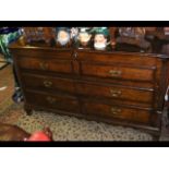 An oak chest with hinged top, two false, one long