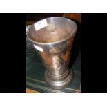A hammered pewter vase mounted with eight George I