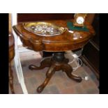 A Victorian walnut fold over games table on carved