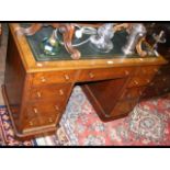 A Victorian walnut nine drawer pedestal desk with