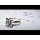 A diamond solitaire ring in designer white gold se
