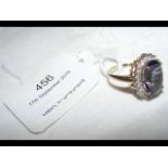 A ladies oval amethyst and diamond ring in 9ct gol