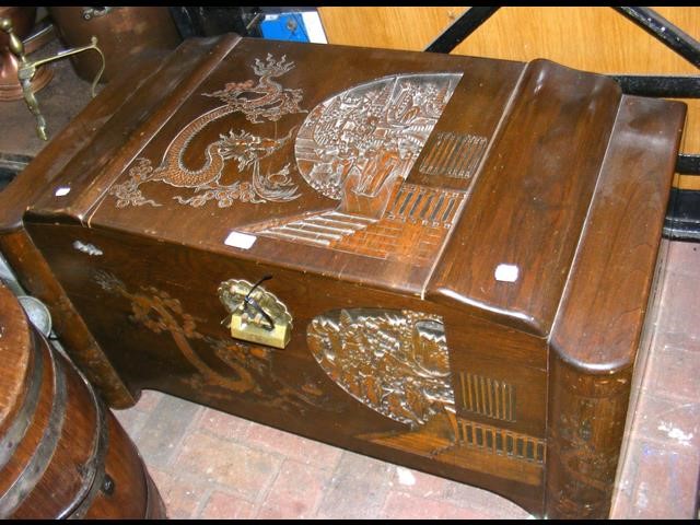 A carved oriental camphor wood box - W100cm
