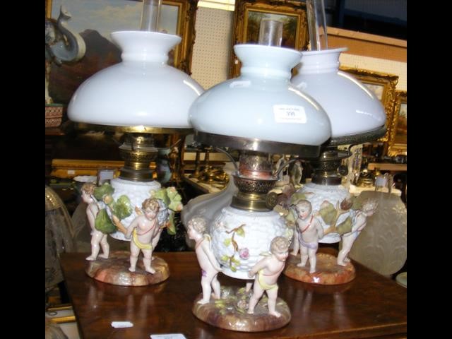 Three oil lamps with reservoirs in the form of bas