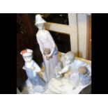 A Lladro figure of woman holding a dog, together w