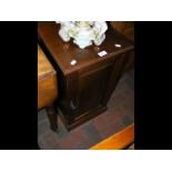 An Edwardian mahogany pot cupboard enclosed by a p