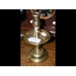 A 17th century brass candlestick and a cut glass r