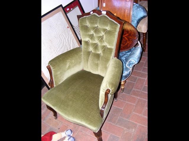 An Edwardian armchair with button back