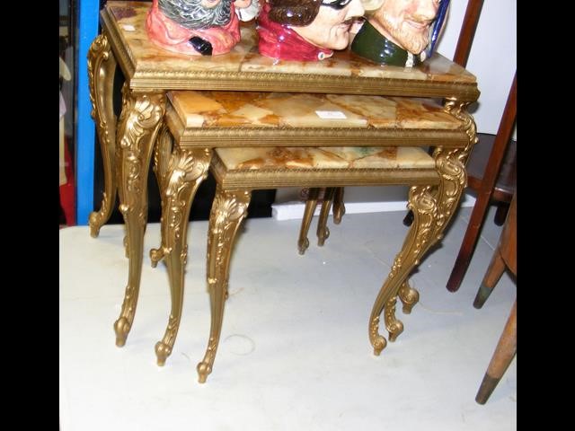 A nest of marble and gilt occasional tables